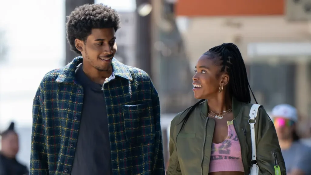 A young man and woman stroll together down the street, representing main characters from Netflix's 