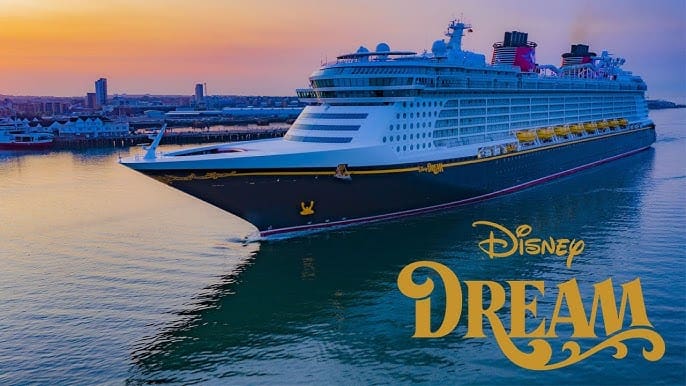 Disney Dream cruise ship docked in the water during sunset with the Disney logo.