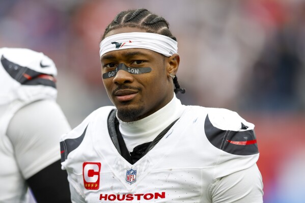 Stefon Diggs wearing a Houston Texans uniform with a headband and eye black.