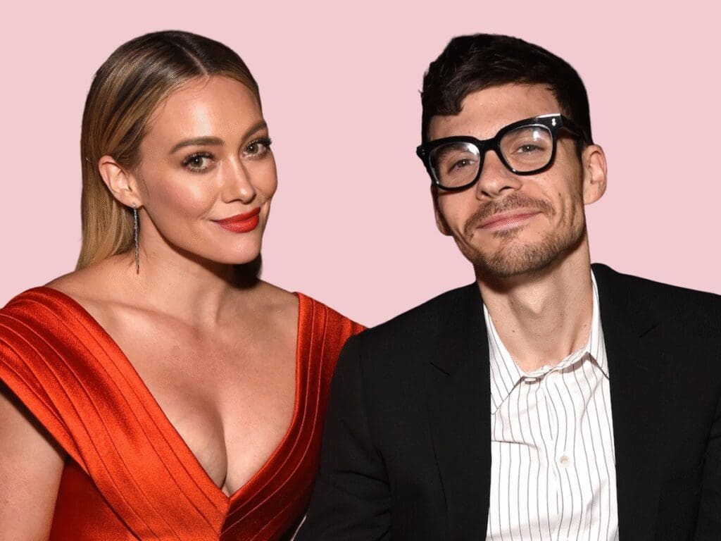 Hilary Duff and Rex Orange County posing together against a pink background.